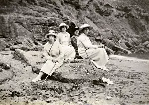 Holidaymaker: Family group sitting on a beach at the seaside