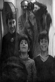 Distorted: Family photo in a funfair distorting mirror