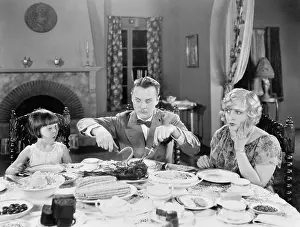 Startle: Family of three sitting together having dinner