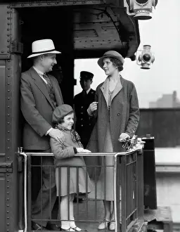 Caboose: Family of three standing at railing at back of