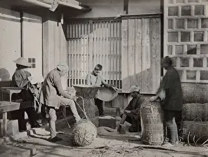 Bales: Farm workers packing bales of rice, Japan
