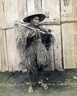 Threshing: Farmer in grass coat, Japan