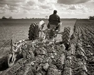Manheim: Farmer on Tractor Plowing a Field