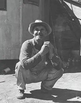 Crouching: A farmer working working as a migrant farm