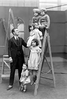 Cautious: Father with children on a ladder