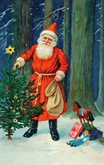Decorates: Father Christmas decorating a Xmas tree