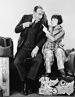 Thirtysomething: Father and daughter sitting together on luggage