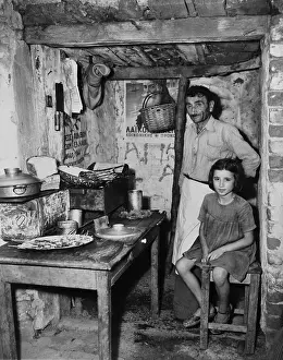 Rightist: Father and daughter in sparse refugee quarters