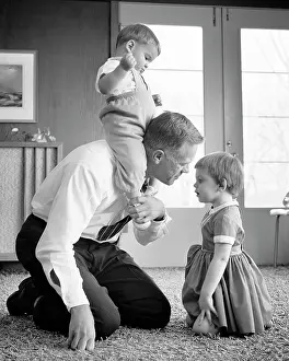 Piggyback: Father Playing on Floor with Children Kneeling