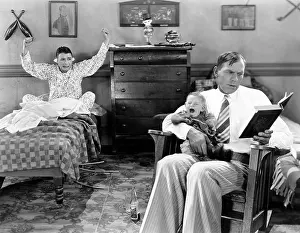 Scream: Father reading with a crying baby and a friend with