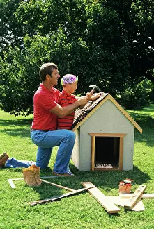 Doghouse: Father and son building dog-house
