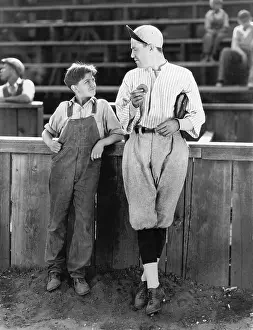 Respectable: Father and son standing together on a baseball field