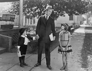 Neighborhoods: Father talking to two children outside