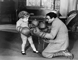 Wholesome: Father and young son playing with boxing gloves