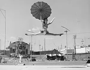 Splits: Female acrobat doing splits on tightrope