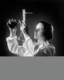 Labs: Female Chemist Scientist Pouring Liquid into a Beaker