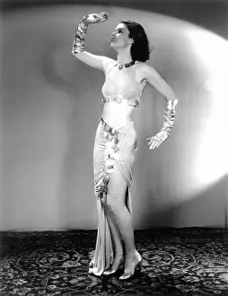 Embellished: Female dancer posing in front of a spotlight