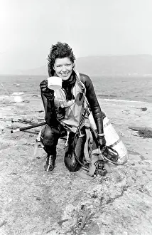Wetsuit: Female diver returning to dry land