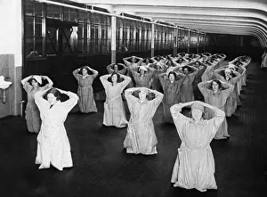 Bent: Female factory workers doing gymnastic exercises, 1925