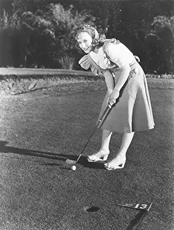 Wedge: Female golfer about to take a shot