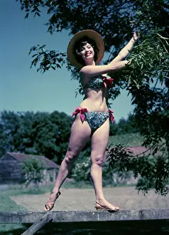Robin Adler: Female model in a bikini, standing on a gate