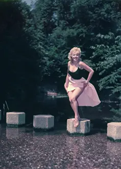Robin Adler: Female model posing on stepping stones