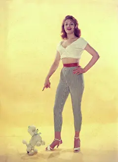 Robin Adler: Female model with toy poodle in studio portrait