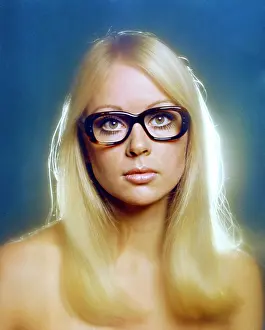 Eyewear: Female model wearing thick-framed spectacles