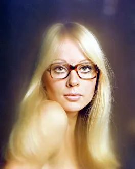 Eyewear: Female model wearing thick-framed spectacles