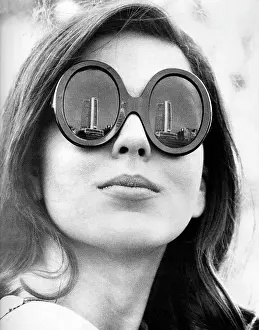 Eyewear: Female model wearing thick-framed sunglasses