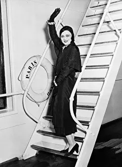 Farewells: Female passenger on boat waving