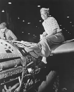 Rosie: A female riveter working on the fabrication of an airplane