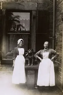 Drainpipe: Two female servants and dog in yard