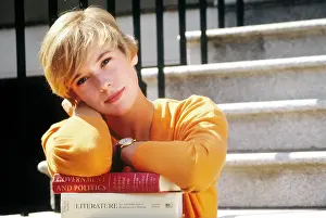 Deg002: Female Student on Steps with Books Leaning on Textbooks