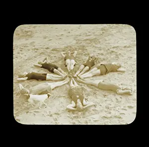 Tendring: Female swimmers lying in a circle on the beach