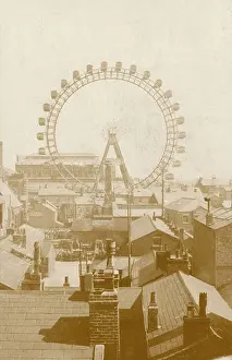 Rooftops: A ferris wheel viewed across the rooftops