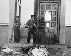 Previously: Fighters of the workers militia examine a