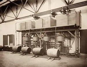 Grayham Chayney: Filling large fuel barrels - Hackney Wick