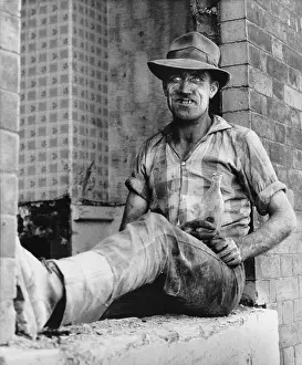 Hulme: Filthy workman sits with a bottle of beer - Hulme