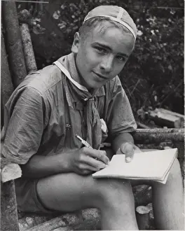 Skullcap: Finnish boy scout writing in a notebook