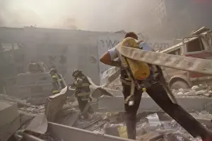 Nyfd: Fire fighters hauling a hose through rubble on September