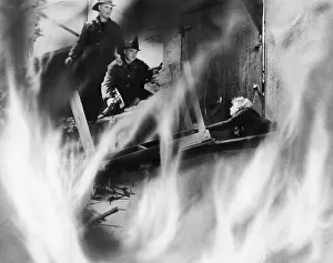 Rescuer: Two fire fighters rescuing a woman