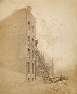 London Fire Brigade: A firefighter in action on a wheeled ladder escape