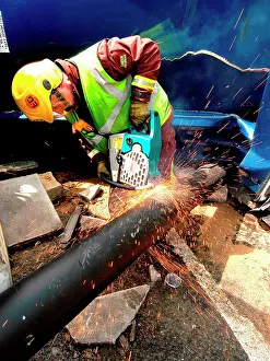 Sparks: Firefighter cutting through pipe after road traffic accident