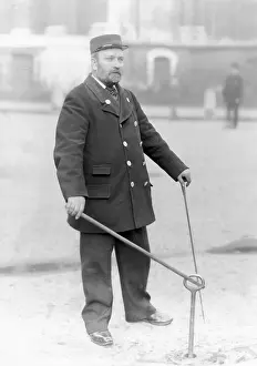 Mains: A firefighter demonstrating the use of a water main key
