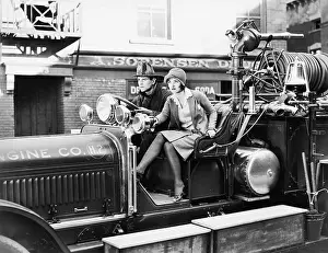 Urgency: Firefighter driving a fire engine and a young woman