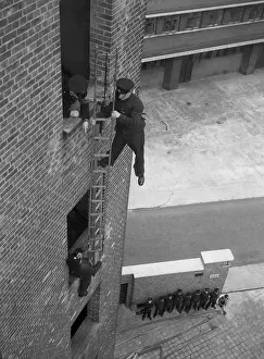 Firefighter during hook ladder practice