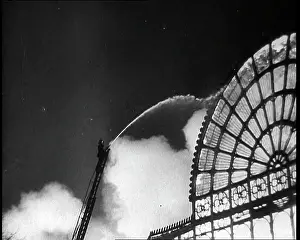 Extinguish: A Firefighter on a Ladder Trying to Extinguish
