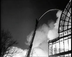 Extinguish: A Firefighter on a Ladder Trying to Extinguish