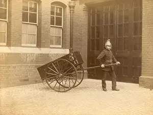 Firefighers: A firefighter of the London Fire Brigade pulling a cart